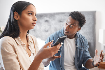 Image showing Couple fight for phone social media text or cheating crisis message in bedroom at house or home. Angry, frustrated and stressed boyfriend in conflict, domestic violence and problem with girlfriend