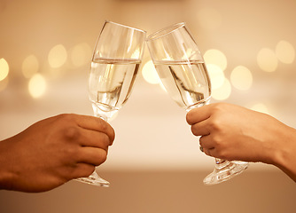 Image showing Champagne, toast and hands, a celebration with couple on romantic date drinking with bokeh. Love, romance and luxury, a man and woman cheers to hope of future relationship goal with glass and bubbles