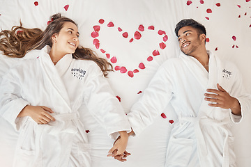 Image showing Man and woman married couple on luxury bed celebrate honeymoon, love and relax in romantic vacation spa hotel. Happy, marriage and young people smile on valentines day with rose heart in bedroom
