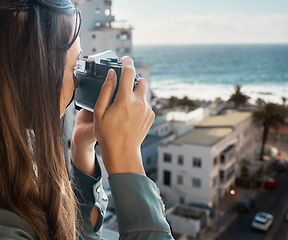 Image showing Travel, view and woman with camera at hotel taking pictures of the city, buildings or ocean on vacation. Photographer, girl on balcony taking photo for happy memory, memories or moments.