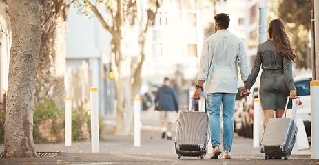 Image showing Couple travel on holiday, walking city street of sydney and honeymoon summer vacation together. Tourist man with luggage, woman with suitcase in road and urban journey to accommodation location