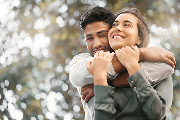 Image showing Happy couple hugging in nature at a park while on a date during a spring vacation with bokeh. Love, care and romantic young man and woman embracing each other in a outdoor garden while on holiday.