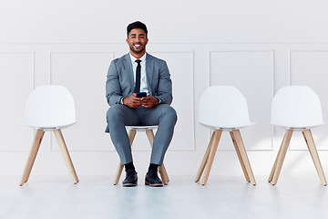 Image showing We are hiring, interview and business man worker waiting for a company management meeting. Portrait of a businessman smile from India on his phone ready for hire process in a office with motivation