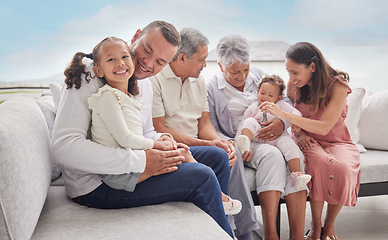 Image showing Family, children and love with a girl her father bonding together at home with their relatives in the living room. Kids, parents and grandparents sitting on a sofa in their house during a visit