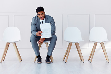 Image showing Hiring, recruitment and business man in a waiting room for a corporate company job interview. Happy, smile and confident career businessman with professional cv ready for job, interview or recruiting