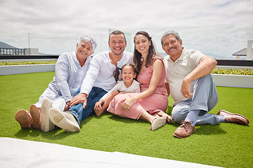 Image showing Portrait of happy big family with girl, love and a smile while sitting on backyard, lawn or grass. Grandfather, grandmother and mom with dad and child or kid bonding outside home in the sunshine.