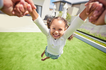 Image showing Happy, motion and child spinning on arms of parent in backyard garden for childhood, fun and bonding. Family, happiness and youth with young girl swing in a circle with hands of father at home