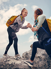 Image showing Hiking, help and friends out on a rock or mountain climbing adventure for fitness, exercise and adrenaline. Happy women with support, travel and assistance while out on cliff and reaching the summit