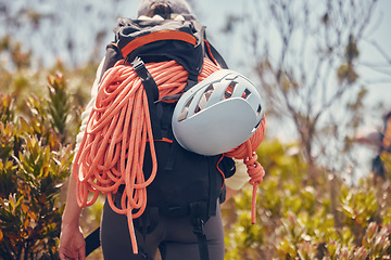 Image showing Sports, mountain and climbing with a person hiking and carrying equipment, rope and a helmet outdoor in nature. Adventure, sport and fitness with an adult on a climb, journey or hike in the forest
