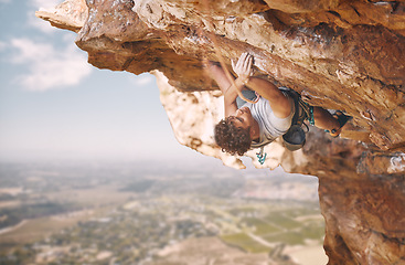Image showing Rock climbing sports and man on mountain cliff for outdoor fitness, wellness goal or workout motivation. Adventure, healthy energy of strong athlete bouldering in safety gear, rope on blue sky nature