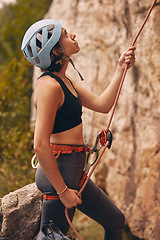 Image showing Rope, rock climber and woman mountain climbing in nature for exercise, endurance and body training outdoors. Fitness, challenge and fearless girl ready to climb a rocky cliff on a dangerous adventure