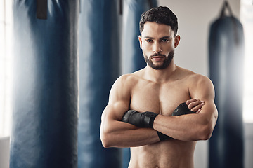 Image showing Fitness, boxer and gym of a man in sports professional for strength and motivation with arms crossed. Portrait of a male in strong and confident boxing at health club by punching bag after training