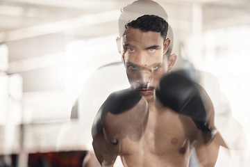 Image showing Boxing, sports and fitness with motion blur and a man boxer training in a gym for health and wellness with special effects. Workout, exercise and fight with a healthy and stong male fighter in gloves