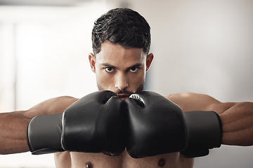 Image showing Fitness, health and a man with gloves for boxing at a gym. Exercise, workout and training for boxer building muscle strength and power for mma. Motivation, sports and healthy competition for fighter.