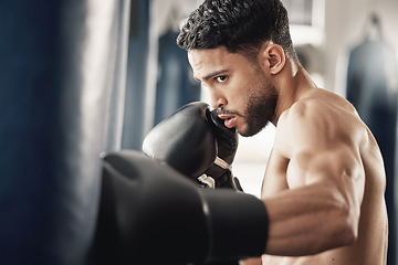 Image showing Training, fitness and workout man boxing punching bag for health, wellness and cardio exercise in gym. Sport, trainer or warrior athlete with strong, healthy motivation for event or sports fight.