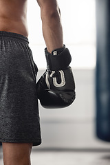 Image showing Boxer, fighter glove and hand close up at sports club or gym for training with equipment for fist. Athlete sportswear for protection for mma and boxing fight or workout with safety gear.