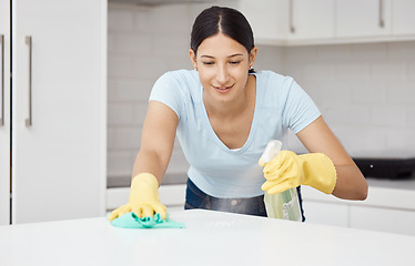 Image showing Cleaning service, table and cleaner in the kitchen working with spray bottle to scrub messy dirt with a cloth and soap detergent. Happy, woman and employee on housekeeping job in gloves with products