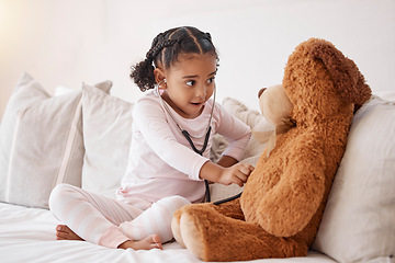 Image showing Learning child with stethoscope check teddy bear with love, healthcare or child development in her bedroom. Smart girl or baby with doll in play pretend game for fun, healthy mind and education