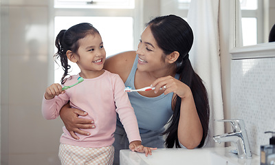 Image showing Mother with girl learning to brush teeth with toothbrush together in bathroom for oral or dental wellness. Happy, love and care mom teaching child or kid about dentistry and cleaning mouth in morning