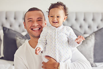 Image showing Happy father smile with baby, on bed in cute moment together in house or apartment in the morning. Excited new dad with young child, show expression of happiness and care in bedroom at family home