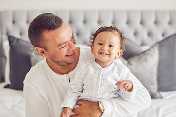 Image showing Happy father relax with baby in bedroom, family home and house for funny, relax and playful morning together. Dad care, love and happiness to cute, smile and infant child, kid and toddler development