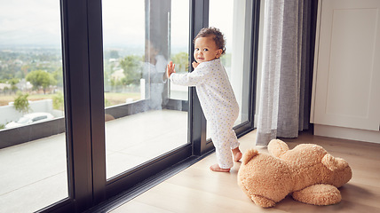 Image showing A baby by window, learning and walking for child development. Baby girl, toddler and young kid standing with support to learn and develop walking skills. Help, first steps and teaching in childcare