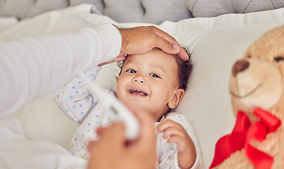 Image showing Baby, sick and fever with a mother checking the temperature of a girl lying in bed at home. Family, healthcare and medicine with a daughter feeling ill or unwell and resting in the bedroom of a house