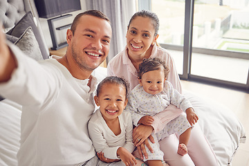 Image showing Selfie, family and children with a mother, father and their girl kids sitting on a bed in their home. Daughter, sister and parents with a man taking a picture while relaxing in a bedroom of the house