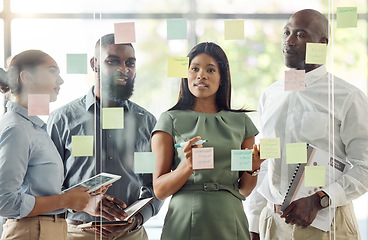 Image showing Sticky notes, meeting and teamwork with diversity in the workplace. Ideas, thinking and working team brainstorming in the office with notes on glass wall. Multicultural, business and corporate group