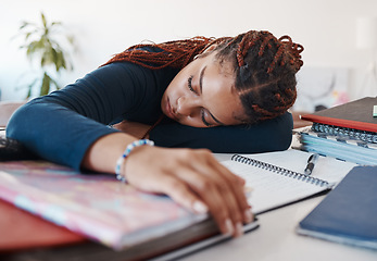 Image showing Tired student sleeping at her desk while studying for university or college exams and test. Burnout young woman lying on desk, fatigue or sleep during study session in her living room at home