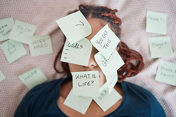 Image showing Black woman on bed, sticky note on face for motivation and success in life. African lady in bedroom, stick paper with questions on skin and eyes, planning strategy, for career and personal goals