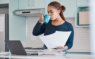 Image showing Business woman working remote drinking coffee, analytics or manager with laptop in kitchen, analyzing paperwork and report. Black woman, worker or employee with finance, accounting or tax audit data