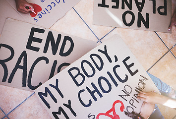 Image showing Writing on protest cardboard sign or banner for racism justice, abortion and global climate change problem. Hands of crowd in support of sustainability, environment and woman rights solution rally