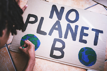 Image showing Environment, cardboard and poster for protest for climate change, global warming and earth day. Global, green and ecology with black man drawing a creative sign for environmental and energy crisis