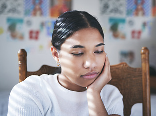 Image showing Depression, anxiety and stress by woman thinking and looking sad, sitting and lonely in her bedroom. Young female suffering with mental health problem after a breakup, bad news or suicide thoughts