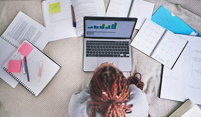 Image showing College education and study laptop on bed with school books and sticky notes in home. University student studying graph, analytics and reading digital learning notes for exam preparation.