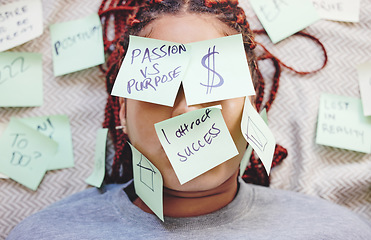 Image showing Black woman tired with sticky note on face, motivation for success and money on bed. African girl in bedroom, stick idea in writing on skin and eyes, for manifestation of dreams of house and wealth