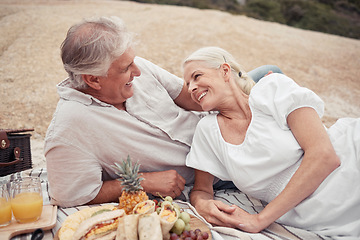 Image showing Love, couple and picnic with a senior man and woman on an outdoor date with food and juice in summer. Happy, smile and romance with an elderly male and female enjoying free time together and bonding