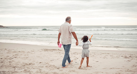 Image showing Family, beach and grandfather holding hands with child and bonding for holiday, support and trust. Summer, vacation and love with grandpa and young girl walking to the sea for break and happiness