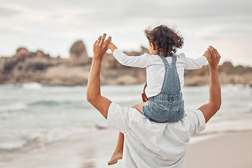 Image showing Beach water, dad and child on family holiday together for a fun summer break to bond in nature. Happy father and kid enjoy ocean vacation with young girl holding parent for balance on shoulders.
