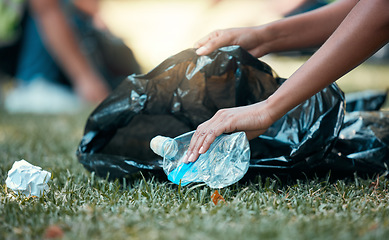 Image showing Hands, plastic bottle and recycling volunteer woman cleaning up garbage and environment trash park problem. Sustainability, eco friendly recycle and volunteering girl with sustainable black waste bag