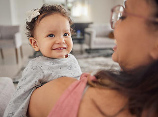 Image showing Family, mother and baby being funny at home, happiness and relax together in the living room at home. Happy, love and comic child and parent laughing at joke and smile with hug for care in house