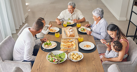 Image showing Family, dinner and people from Mexico eating food at a event, holiday celebration or home meal. Talking, conversation and speaking together at the table with kids, grandparents and parents at a house