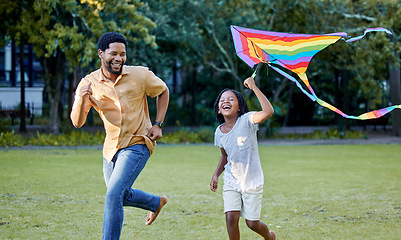 Image showing Happy girl and father playing a kite while learning or running in a park, garden or lawn outdoor. Black family bonding, fun and happiness while laugh, smile and joy together with cute and daughter