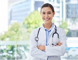 Image showing Healthcare, doctor or nurse woman with stethoscope in hospital, bokeh and happy with smile. Health, trust and mission professional medical expert or worker with wellness motivation and vision