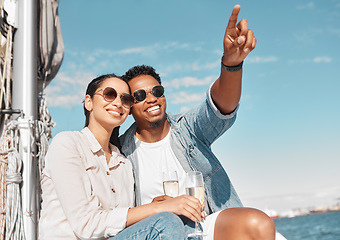 Image showing Couple, champagne and pointing on luxury yacht for summer holiday, anniversary celebration and travel in Monaco. Smile, happy or love bond man and woman on ocean or sea water boat for relax honeymoon