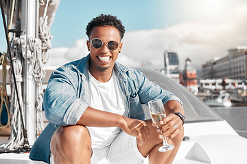 Image showing Happy, sea and man on a luxury yacht or catamaran enjoying a glass of champagne on a summer holiday alone. Lifestyle, smile and young person in sunglasses drinking wine on cruise boat to relax at sea