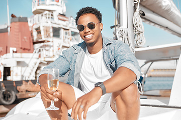 Image showing Luxury, wine glass and man on a yacht for holiday vacation on the ocean or sea with sunglasses. Gen z entrepreneur portrait enjoying his wealth with champagne glass on cruise boat travel in summer