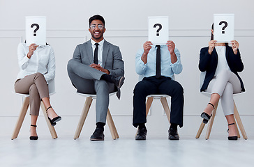 Image showing Man at in line at hiring company smile for interview, in waiting room to see manager or boss. Professional male in group of people with question mark paper or posters over face for job recruitment