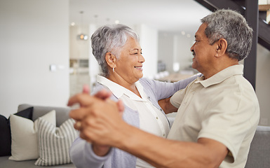 Image showing Love, dancing and happiness with a senior couple being playful and romantic while celebrating their anniversary or retirement at home. Happy man and woman bonding together in a healthy relationship